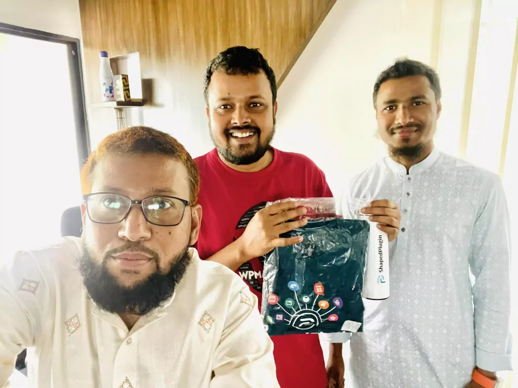 Lead organizer of WordCmp Sylhet collects swag from ShapedPlugin's CEO